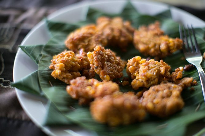 PRIVATE Balinese Cooking Class in Ubud with Dewa with Transfers - Grinding spices and cooking over wood fire
